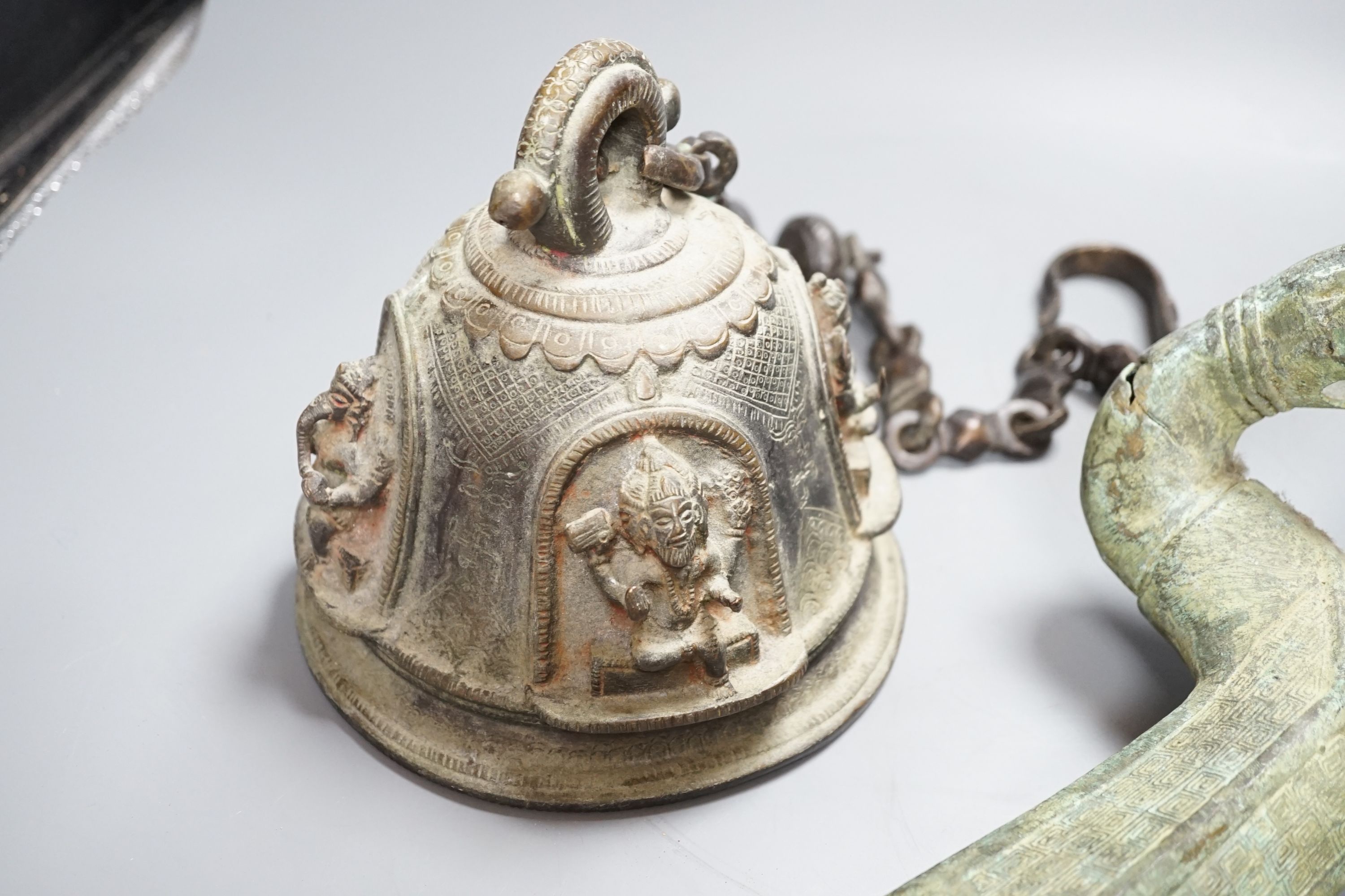 A large, archaic tic bronze figure, 76cm, and a bronze bell on chain